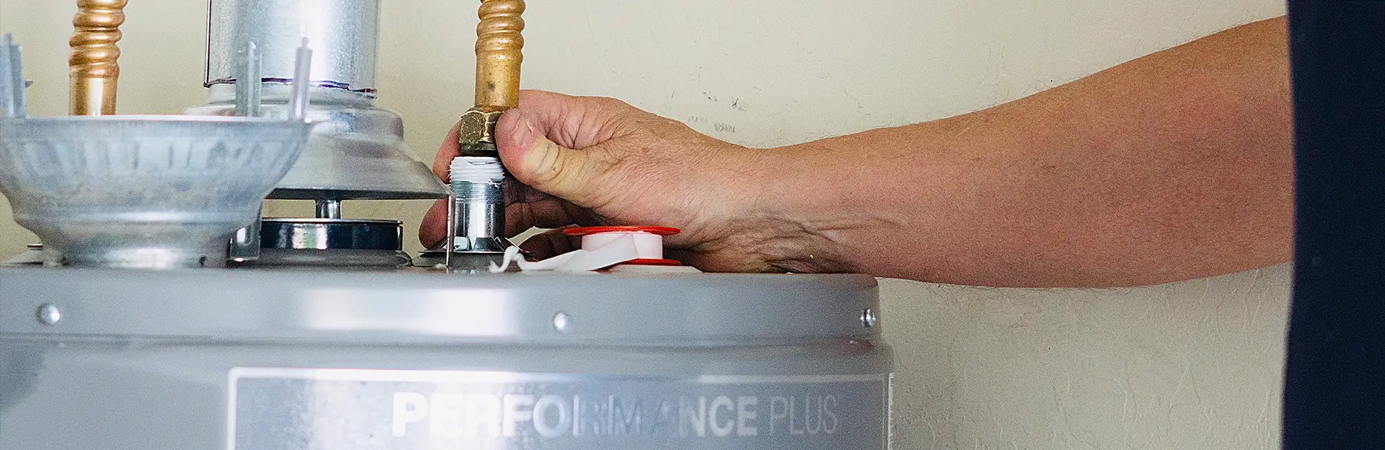 hand working on water heater