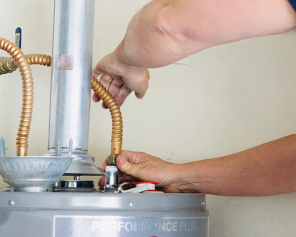 hand working on water heater